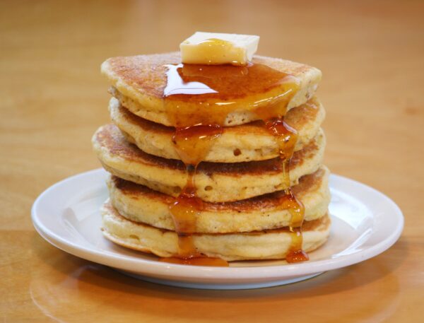 Pancakes made from Cornmeal Pancake Mix covered with syrup and butter