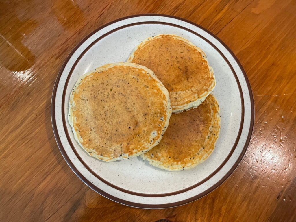 Lemon Poppyseed Pancakes made using Polly's Pancake Parlor pancake mix on a plate